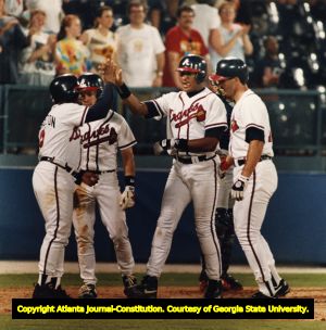 Atlanta Braves' Cabrera, Bream, Lemke, and Pendleton celebrate at home plate after a grand slam, 1993