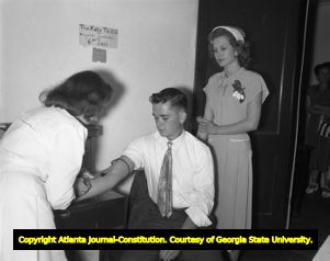 Engaged couple gives blood to be tested before getting their marriage license, 1952