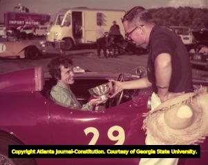 Audrey Saffel accepting her trophy for winning the Belle's Classic race, 1957