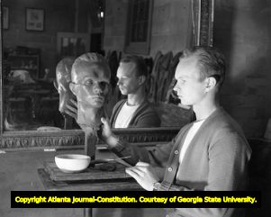 Art student creating a self-portrait bust, 1950