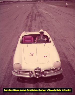 Woman racer in an Alfa Romeo sports car, 1957