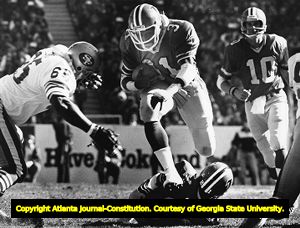 Falcons' William Andrews hurdles a defender against the 49ers, 1980