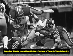 Falcons' William Andrews dragging a defender, 1981