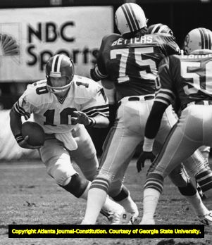 Falcons' Steve Bartkowski avoids the Miami Dolphins' pass ruch, 1980