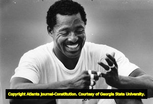 Falcons' Billy "White Shoes" Johnson untapes his fingers at football practice, 1985