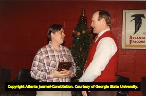 Retired Falcons' linebacker Tommy Nobis presenting an award, 1989