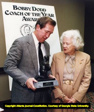 Coach Bobby Ross receiving the Bobby Dodd Coach of the Year Award from Alice Dodd, 1991