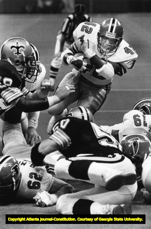 Falcons' Gerald Riggs dives over some New Orleans Saints to score a 2 yard touchdown, 1985