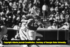 Falcons' quarterback Chris Miller drops back to pass, circa 1980s