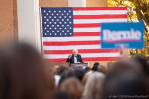 Bernie Sanders points at the crowd while giving them a speech