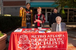 A group of students man a stand for the Democratic Socialists of America