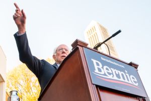 Bernie Sanders points at the crowd while giving a speech