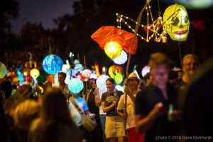 A crowd watches paper lantern parade