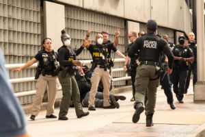 Police Officers begin pointing other officers away from the scene