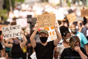 A protester holds up a sign reading 'Black Lives Matter'