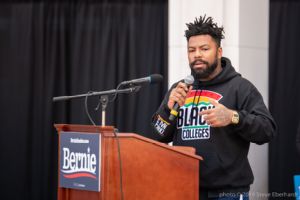 A man gives a speech to the crowd