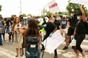 A protester approaches the news reporter and interupts her newscast