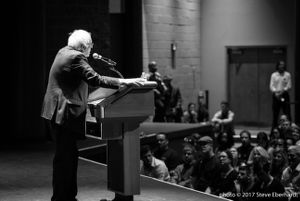 Bernie Sanders speaks to a crowd while at an event to promote his new book (grayscale)