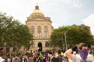 Protesters begin to gather together after their march through the streets