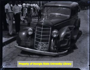 Wrecked car with a crowd of onlookers, Atlanta, Georgia, circa late 1930s or early 1940s