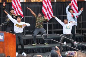 A group of fraternity brothers perform on stage