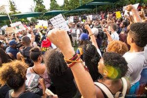 Protesters hold their fists in the air