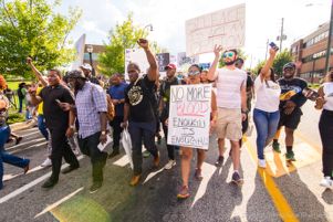 Protesters holding signs while marching