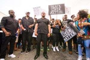 Daniel Blackman, Gerald Durley, Francys Johnson, and Gerald Griggs stand at the beginning of the protest