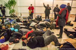 Protestors partake in a die-in at the CNN Center