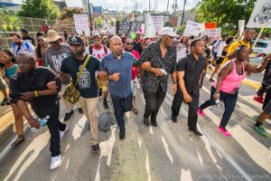 Protesters interlock arms as they march through the street