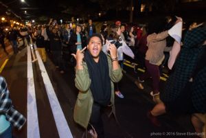 A protester marches with others protesting Trump's election