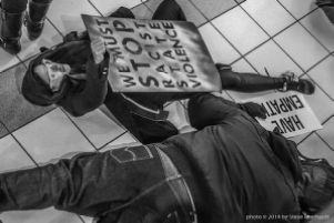Protestors partake in a die-in at the CNN Center