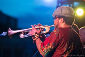 Dashill Smith plays trumpet facing the audience; StillImage