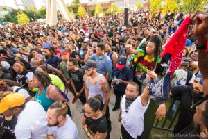 Protesters gather together as they listen to a speech being made