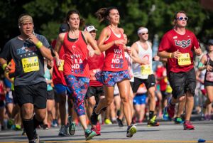 A group of runners wearing American Flag themed clothes continue their race