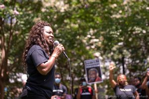 Monica Robinson uses a microphone to give a speech