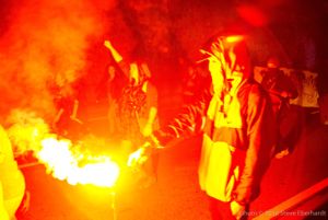 Protesters light the way through their protests using flares