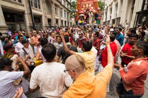 Participants raise their hands in the air as they gather together