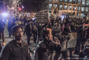 Protesters march through downtown Atlanta holding signs