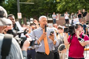 Congressman Hank Johnson gives a speech to gathered around protesters and news stations