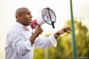 Mawuli Davis uses a bullhorn to give a speech to fellow protesters