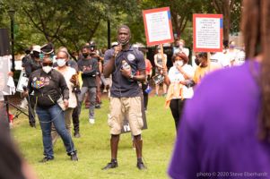 Ahmaud Arbery's family gives a speech into a microphone calling for justice