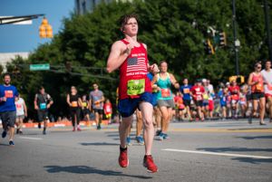 A runner leaps completely off the ground as he continues to run by