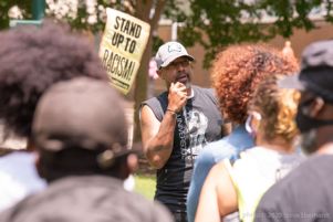A protester uses a microphone to speak to other protesters at the rally