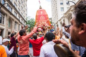 Participants hold their hands in the air as they celebrate