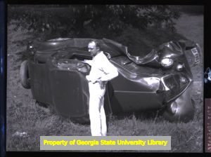 A car flipped on its side, Atlanta, Georgia, circa late 1930s or early 1940s