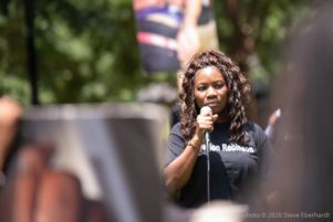 Monica Robinson uses a microphone to give a speech