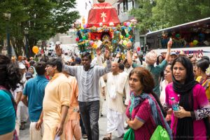 Participants hold their hands in the air as they walk