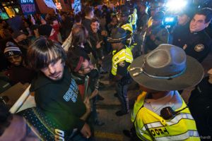 Protesters link arms as they stand off with Police Officers
