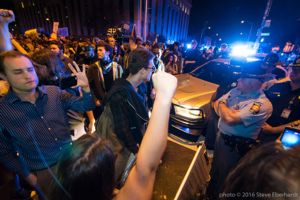 Protesters begin streaming and recording their protest as Police Officers arrive
